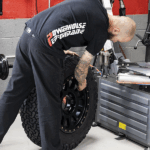 Car wheels being professionally balanced with a wheel balancer to ensure a smooth ride, prevent vibrations, and protect tires and suspension.
